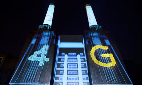 Battersea Power Station at night with 4G projected in light across its chimneys
